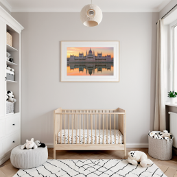 An Art Wall Room Mockup generated with AI for Print On Demand Seller. The mockup features a Scandinavian Style Nursery Room with a framed photography print of the Budapest Hungarian Parliament at sunrise hanged on the wall