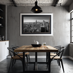 An Art Wall Room Mockup generated with AI for Print On Demand Seller. The mockup features an Industrial Style Dining Room with a framed photography print of the New York Manhattan Skyline hanged on the wall