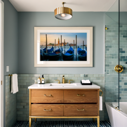 An Art Wall Room Mockup generated with AI for Print On Demand Seller. The mockup features a Mid Century Modern Style Bathroom with a framed photography print of the Venice Grand Canal and its Gondola on the wall