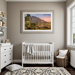 An Art Wall Room Mockup generated with AI for Print On Demand Seller. The mockup features a Modern Farmhouse Style Nursery Room with a framed photography print of a the Teotihuacan Pyramids and Cactus at sunrise on the wall