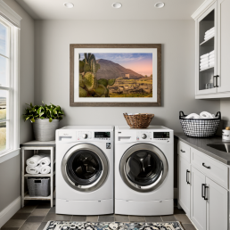 An Art Wall Room Mockup generated with AI for Print On Demand Seller. The mockup features a Modern Farmhouse Style Laundry Room with a framed photography print of a the Teotihuacan Pyramids and Cactus at sunrise on the wall
