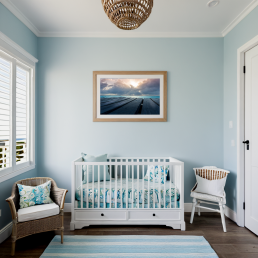 An Art Wall Room Mockup generated with AI for Print On Demand Seller. The mockup features a Coastal Style Nursery Room with a framed photography print of a cloudy sunset over a Caribean Sea on the wall