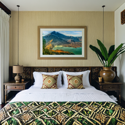 An Art Wall Room Mockup generated with AI for Print On Demand Seller. The mockup features a Balinese Style Bedroom with a framed photography print of the Rinjani Volcano Rim at sunrise on the wall