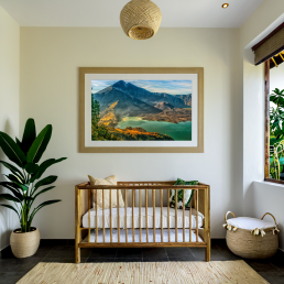 An Art Wall Room Mockup generated with AI for Print On Demand Seller. The mockup features a Balinese Style Nursery Room with a framed photography print of the Rinjani Volcano Rim at sunrise on the wall