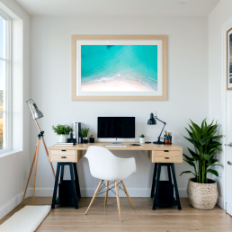 An Art Wall Room Mockup generated with AI for Print On Demand Seller. The mockup features a Coastal Style Home Office Room with a framed photography print of a beautiful tropical beach from the sky hanged on the wall